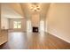 Open living room with wood-look floors, fireplace, and high ceilings at 921 Park Place St, Social Circle, GA 30025