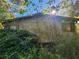 Side view of house showing siding and overgrown vegetation at 2281 Carr Ne Rd, Conyers, GA 30012