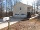 Rear view of a house featuring a two-car garage and deck at 434 Spring Leaf Dr, Dallas, GA 30157