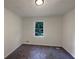 Simple bedroom with carpet, window, and neutral walls at 208 Ashland Dr, Stockbridge, GA 30281