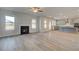 Open living room with hardwood floors and a gas fireplace at 63 Homesite Cooper W Cv, Fayetteville, GA 30214