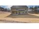Two-story house with backyard patio and grassy yard at 63 Homesite Cooper W Cv, Fayetteville, GA 30214