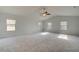 Large main bedroom with tray ceiling, ceiling fan, and ample natural light at 63 Homesite Cooper W Cv, Fayetteville, GA 30214
