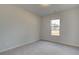 Well-lit bedroom with neutral walls and carpeted floors at 63 Homesite Cooper W Cv, Fayetteville, GA 30214