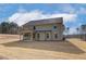 Two-story house with backyard patio and grassy yard at 63 Homesite Cooper W Cv, Fayetteville, GA 30214
