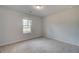 Well-lit bedroom with neutral carpeting and a window at 63 Homesite Cooper W Cv, Fayetteville, GA 30214