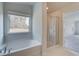 Relaxing bathroom with soaking tub and glass-enclosed shower at 63 Homesite Cooper W Cv, Fayetteville, GA 30214
