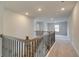 Upstairs loft overlooking the main floor with neutral carpeting at 63 Homesite Cooper W Cv, Fayetteville, GA 30214