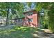 Brick house with a large green lawn and mature trees at 2953 Collier Nw Dr, Atlanta, GA 30318