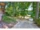 Concrete driveway leading to a home surrounded by trees at 2953 Collier Nw Dr, Atlanta, GA 30318