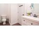 Simple bathroom with white vanity, toilet and dark wood flooring at 4619 Spring St, Acworth, GA 30101