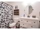 Clean bathroom with white vanity, large mirror, and a whimsical shower curtain at 4619 Spring St, Acworth, GA 30101