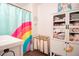 Cheerful bathroom with rainbow shower curtain and linen storage cabinet at 4619 Spring St, Acworth, GA 30101