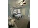 Light blue bedroom with gray carpet and bay window at 1958 Stonewood Dr, Lithia Springs, GA 30122