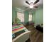 Light green bedroom with twin bed and wood floors at 1958 Stonewood Dr, Lithia Springs, GA 30122