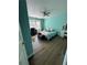 Teal bedroom with a queen bed and wood floors at 1958 Stonewood Dr, Lithia Springs, GA 30122