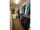 Walk-in closet with shelving and hanging rods at 1958 Stonewood Dr, Lithia Springs, GA 30122