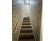 Carpeted staircase with floral wallpaper at 1958 Stonewood Dr, Lithia Springs, GA 30122