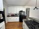 White kitchen cabinets with gas range and refrigerator at 1958 Stonewood Dr, Lithia Springs, GA 30122