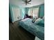 Teal bedroom with a queen bed and wood floors at 1958 Stonewood Dr, Lithia Springs, GA 30122