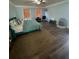 Main bedroom with teal bed and wood-look floors at 1958 Stonewood Dr, Lithia Springs, GA 30122