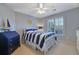 Well-lit bedroom featuring a blue and white striped bedding set and a white dresser at 1620 Silverleaf Way, Alpharetta, GA 30005