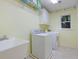 Laundry room with washer, dryer, utility sink, and overhead storage at 1620 Silverleaf Way, Alpharetta, GA 30005