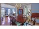 Bright dining room with hardwood floors, chandelier, and view into kitchen at 1620 Silverleaf Way, Alpharetta, GA 30005