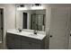 Modern bathroom with double vanity, large mirror, and shower at 3940 Foxdale Ln, Cumming, GA 30028