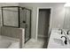 Modern bathroom featuring dual sinks, glass shower, and soaking tub at 3940 Foxdale Ln, Cumming, GA 30028