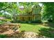 Two story home with wraparound porch and mature trees at 4671 Collins Ave, Acworth, GA 30101