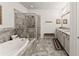 Spa-like bathroom with a soaking tub, walk-in shower, and granite countertops at 2536 Skyland Ne Dr, Atlanta, GA 30319