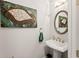 Stylish powder room with pedestal sink and oval mirror at 2536 Skyland Ne Dr, Atlanta, GA 30319