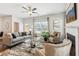 Bright living room with fireplace and large windows, featuring comfortable seating at 2527 Swan Lake Dr, Grayson, GA 30017