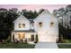 Two story farmhouse style home with front porch and attached garage at 118 Henley St, Canton, GA 30114