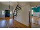 Bright entryway with hardwood floors, black front door, and staircase at 38 S Broad St, Porterdale, GA 30014