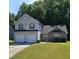 Two-story house with two-car garage and landscaped yard at 405 Pecan Wood, Fairburn, GA 30213