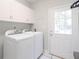 Laundry room with white cabinets, washer, dryer, and door to exterior at 436 Westlake Dr, Marietta, GA 30064