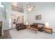 Living room with high ceiling, fireplace, leather furniture, and view of the foyer at 436 Westlake Dr, Marietta, GA 30064