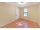 Simple bedroom with hardwood floors and large window at 3884 Wood Path Dr, Stone Mountain, GA 30083