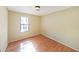 Simple bedroom with hardwood floors and large window at 3884 Wood Path Dr, Stone Mountain, GA 30083