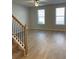 Bright living room with wood-look floors and stairwell at 8194 Tiger Way, Riverdale, GA 30247