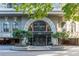 Building entrance with arched entryway and landscaping at 3334 Peachtree Ne Rd # 1209 1210, Atlanta, GA 30326