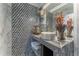 Upscale bathroom with a unique geometric tile accent wall and marble countertop at 3334 Peachtree Ne Rd # 1209 1210, Atlanta, GA 30326