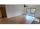Spacious living room with hardwood floors and sliding glass doors at 6851 Roswell Rd # O9, Atlanta, GA 30328