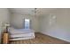 Bright bedroom with hardwood floors, window, and a lamp at 6851 Roswell Rd # O9, Atlanta, GA 30328
