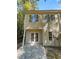 Two-story home with light-yellow siding and private patio at 20 Pine Canyon Sw Dr # 24, Atlanta, GA 30331
