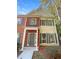 Two-story townhome with gray door and brick facade at 20 Pine Canyon Sw Dr # 24, Atlanta, GA 30331