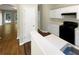 Kitchen with white cabinets, black appliances, and view into living room at 20 Pine Canyon Sw Dr # 24, Atlanta, GA 30331