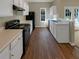 Modern kitchen with white cabinets, black appliances and access to backyard at 20 Pine Canyon Sw Dr # 24, Atlanta, GA 30331